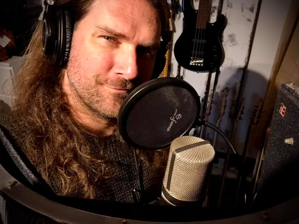 Photo of KG behind the vocal mic
